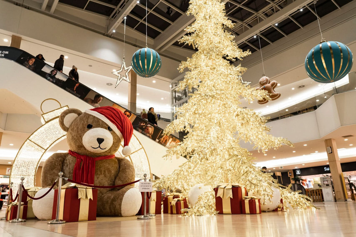 9.8' inflatable teddy bear with soft beige fur and festive scarf for indoor use; 63 lb, unlit, includes 580W ventilator.