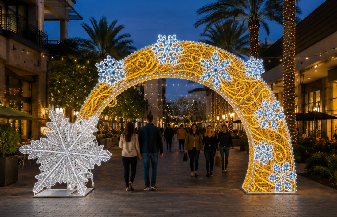 Steel frame illuminated snowflake arch installed outdoors at a public venue
