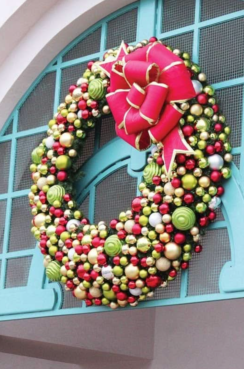Decorative wreath with large multi loop red bow
