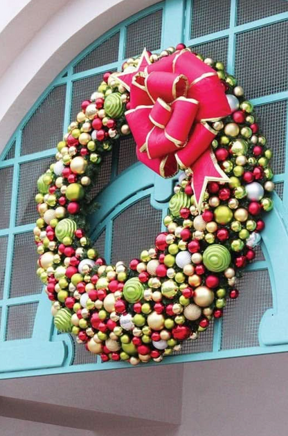 Decorative wreath with large multi loop red bow