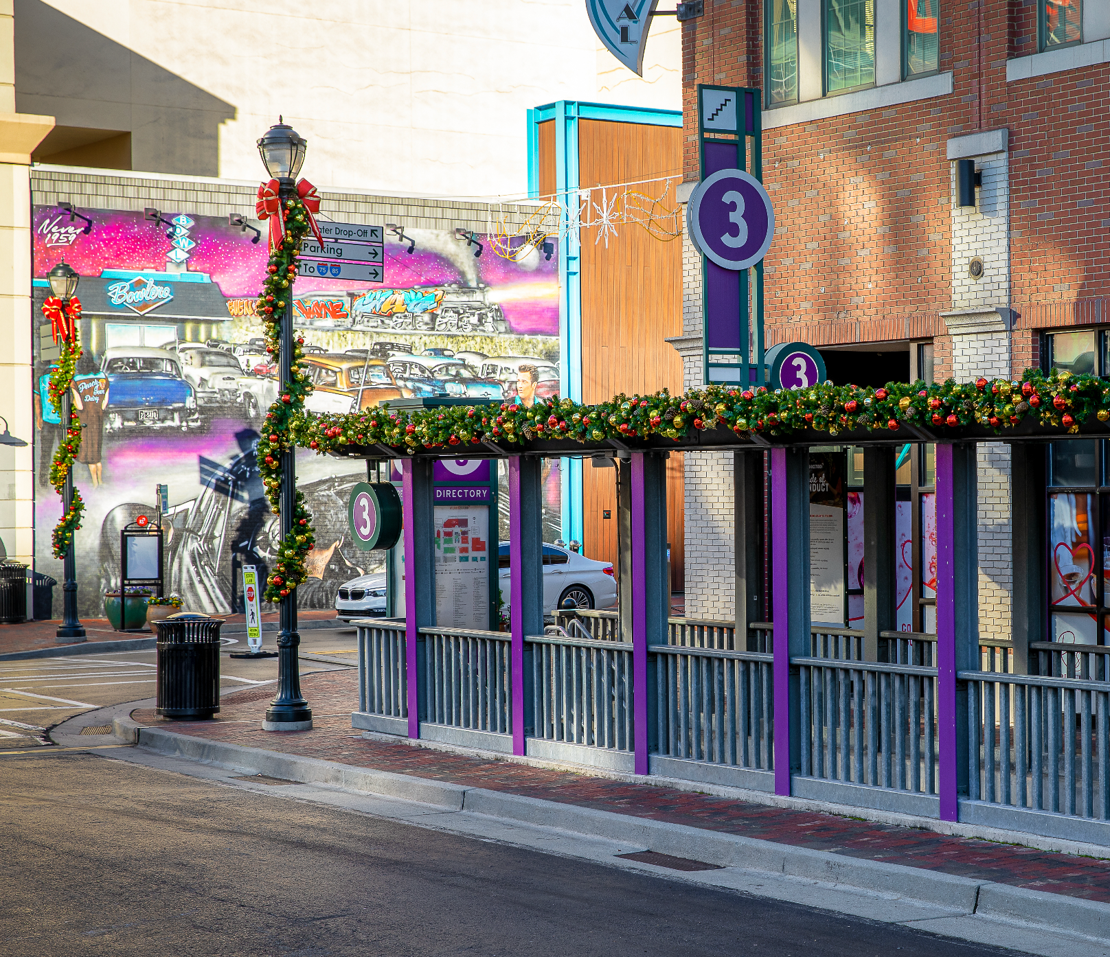 Decorative street scene with festive commercial garlands and decor for exterior mixed use development