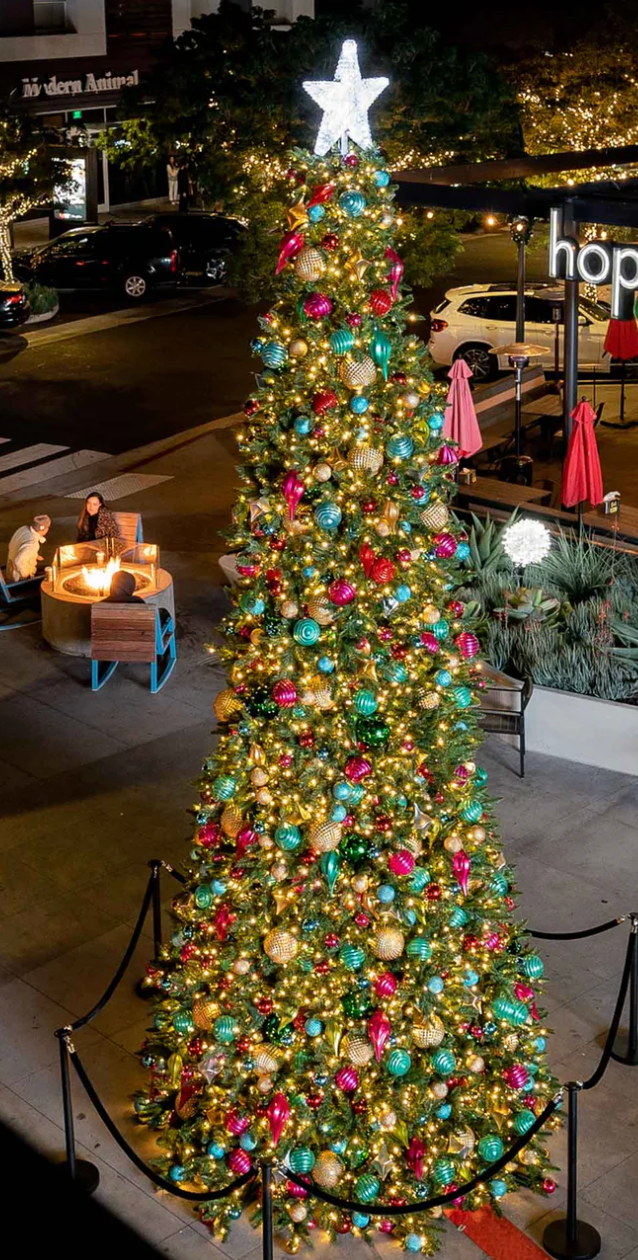 Large commercial Christmas tree low voltage with ornaments in plaza