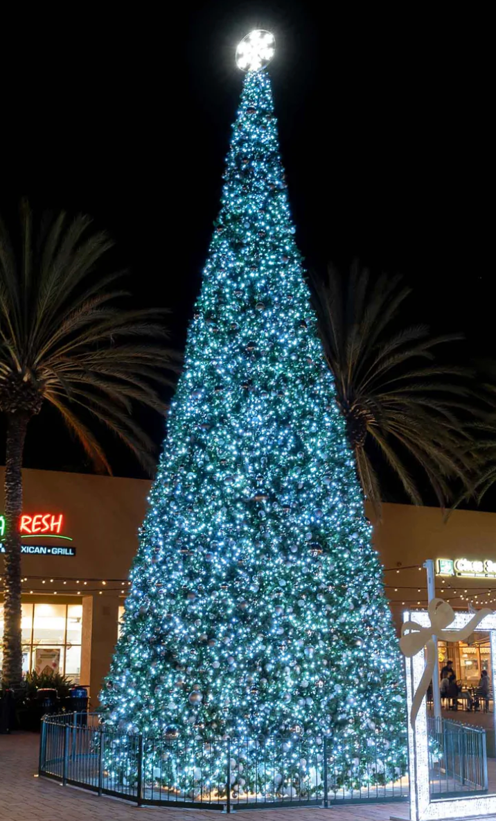 Large commercial Christmas tree low voltage in plaza with topper
