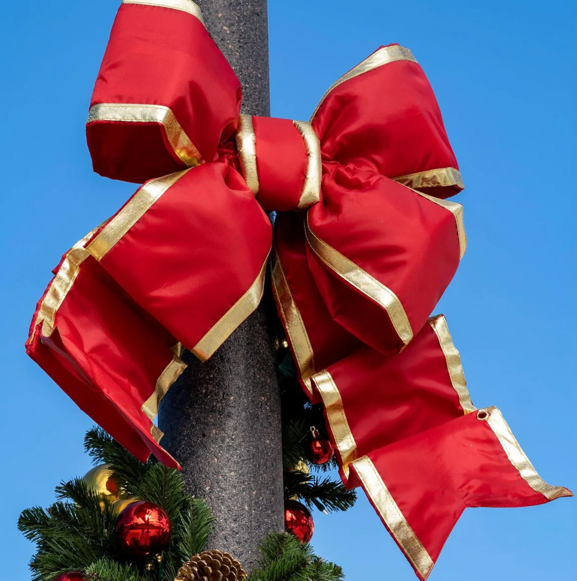 Red structural commercial Christmas bow with gold trim