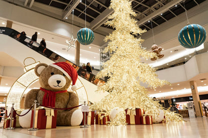 9.8' inflatable teddy bear with soft beige fur and festive scarf for indoor use; 63 lb, unlit, includes 580W ventilator.