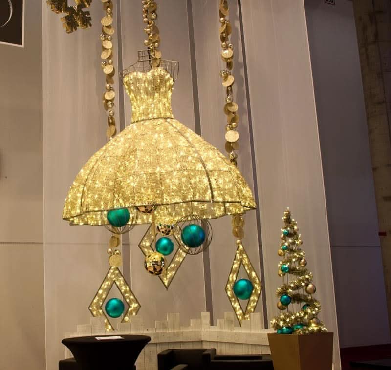Built on a gold frame with warm white LED mini lights woven through clear silicone netting