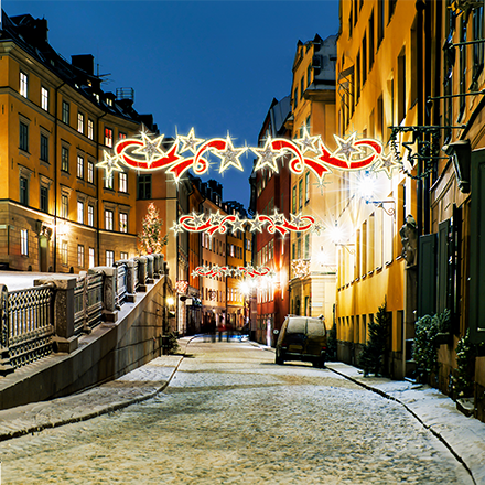 Star Swirl with Ribbon overhead décor, red ribbon and red plus warm-white LEDs for commercial overheads